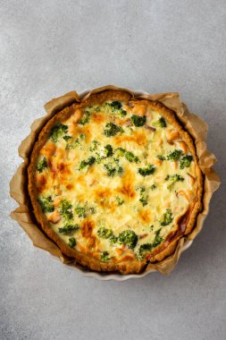 Homemade pie with red fish and broccoli, quiche with salmon and char, cheese and cream