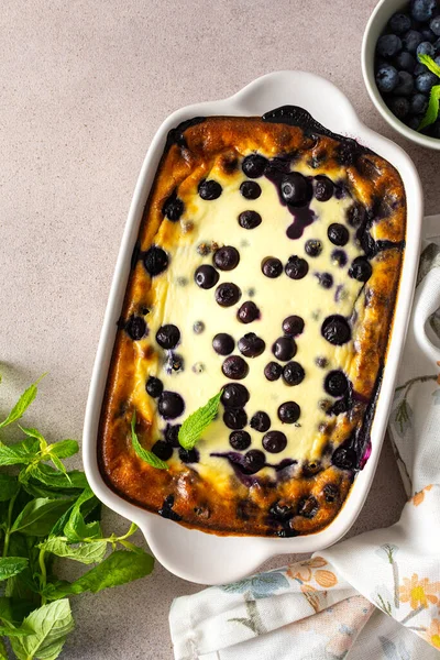 Delicious sweet cheesecake with blueberries in an oval dish, top view