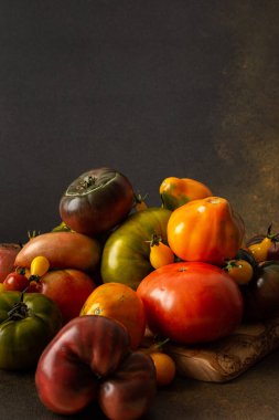 Ripe juicy colorful tomatoes of different varieties close-up, organic seasonal products from the market, farm harvest