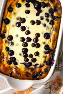 Delicious sweet cheesecake with blueberries in an oval dish, top view