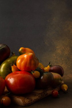 Ripe juicy colorful tomatoes of different varieties close-up, organic seasonal products from the market, farm harvest