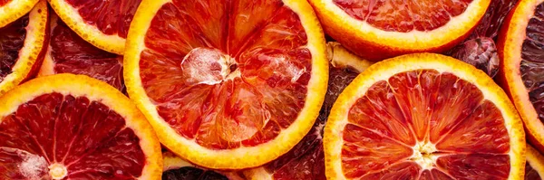 Fruit banner with blood oranges and ice, delicious sweet fruit, top view