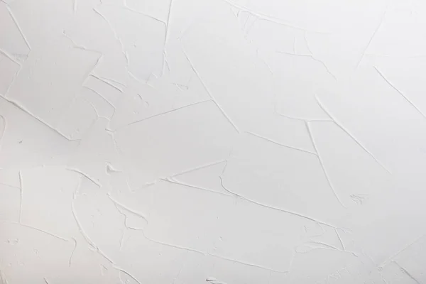 Grote slagen witte pleister. De achtergrond is gemaakt van wit gips met een ruw oppervlak. — Stockfoto