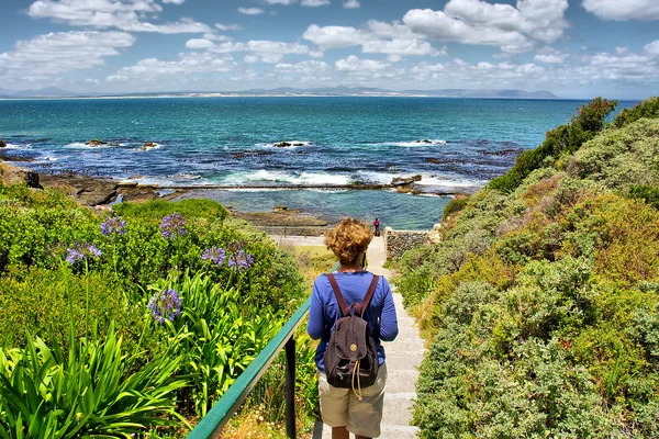 Woman looks at sea from awesome garden — Stock Photo, Image