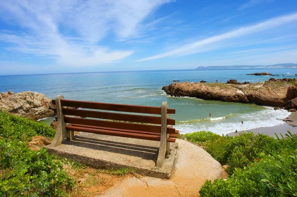 Red bench on cliff rocks — Stock Photo, Image