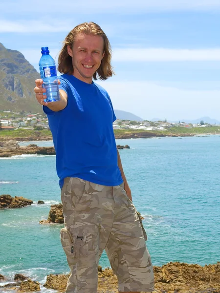 Smiling man offers water — Stock Photo, Image
