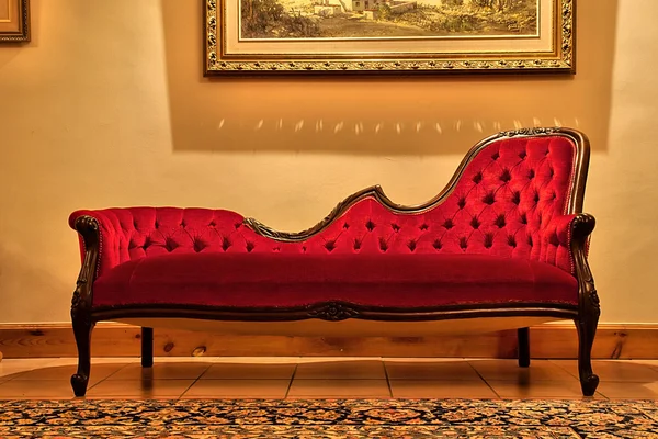 Expensive red sofa under painting — Stock Photo, Image