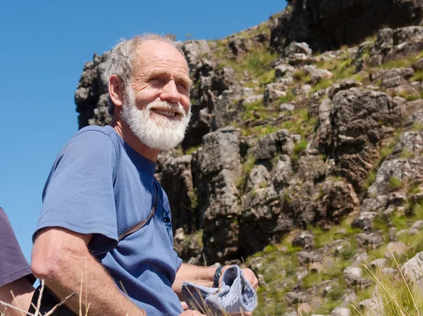 Happy old man in mountains — Stock Photo, Image