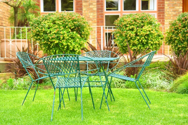 Outdoor chairs on lawn — Stock Photo, Image