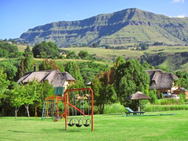 Children playground on estate in mountains clipart