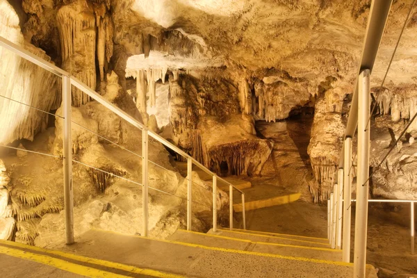 Stairs in a cave leading to a huge chamber — Stock Photo, Image