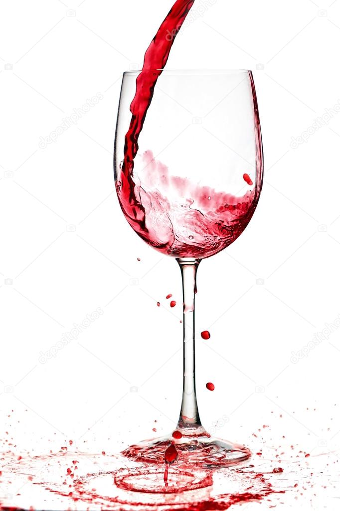 red wine being poured into a wine glass from a height