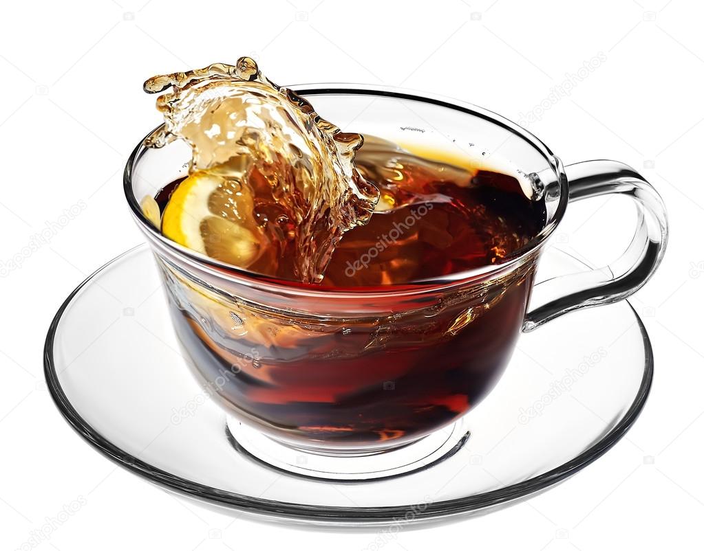 hot tea splashes as a lemon slice or sugar cube is dropped into