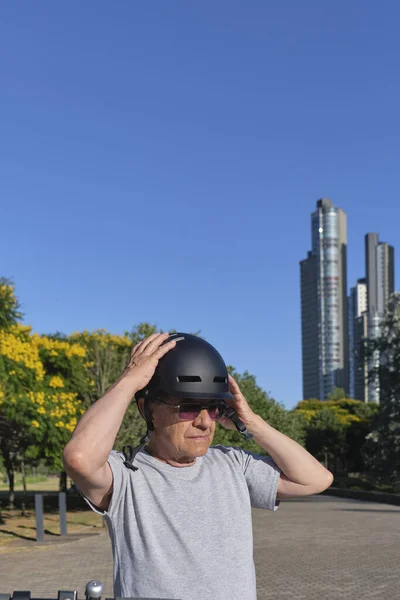 市内の公園でスポーツヘルメットをかぶっている上級のヒスパニック系男性 積極的な都市生活の概念 良いと道路の安全を感じます — ストック写真
