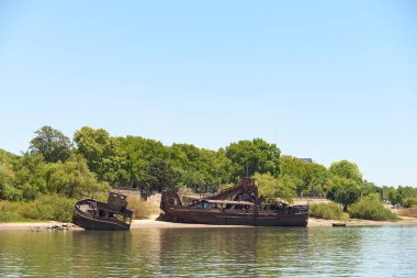 Dec 30, 2021, Colon, Entre Rios, Argentina: Abandoned rusty boats on the shore of the Uruguay River.