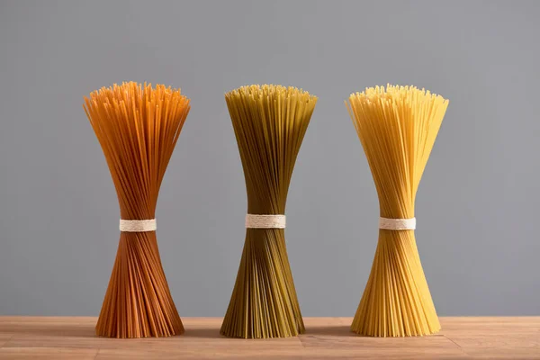 Pasta Three Bunches Raw Spaghetti Different Colors Wooden Table Concepts — Zdjęcie stockowe