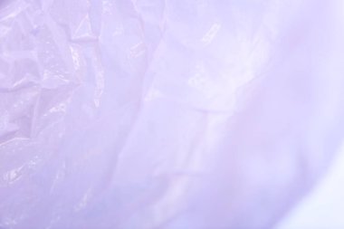 Green and purple background, single use plastic bags. Concepts: sustainability, recycling, pollution.