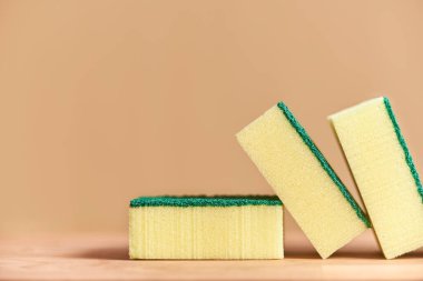 Three yellow and green dishwashing sponges. Image with copy space.