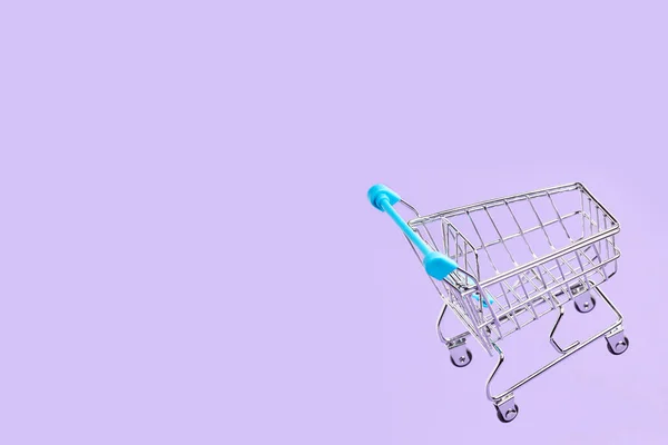 Empty Shopping Cart Light Blue Details Flying Pastel Lilac Background — Stock Photo, Image