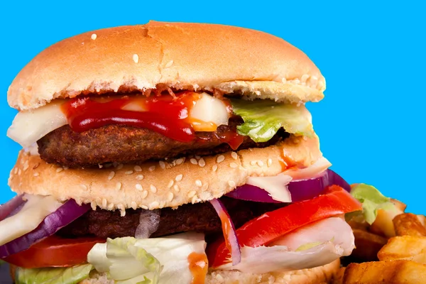 Hamburger with fries isolated on blue background — Stock Photo, Image