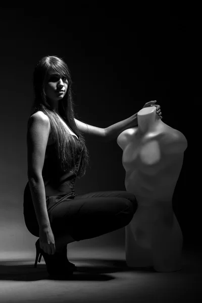 Woman with mannequin in the dark — Stock Photo, Image