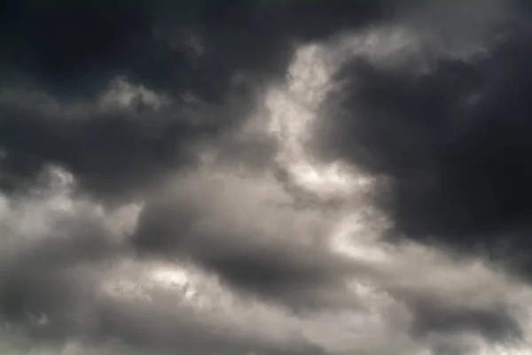 Dark and gray clouds formations in the sky. Only sky image, no land.