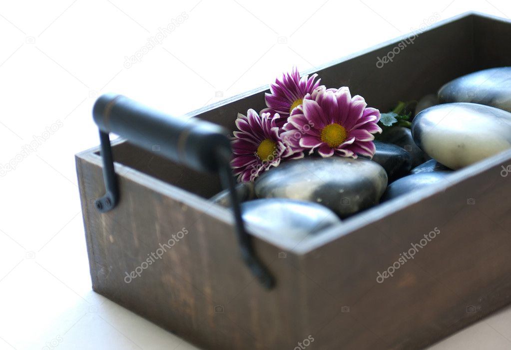 Wooden box with Hot Stones for wellness and massage