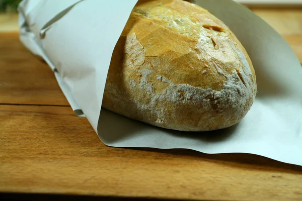 Baked bread in paper — Stock Photo, Image