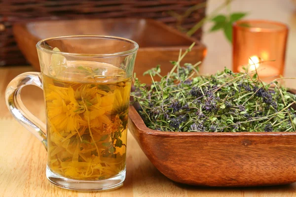 Herbs in glass and bowl — Stock Photo, Image