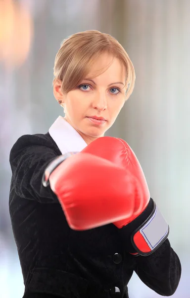 Portrait of young female entrepreneur wearing boxing gloves — Stock Photo, Image