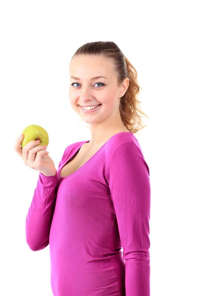 Young cheerful woman in sports wear with apple, isolated over wh Royalty Free Stock Photos