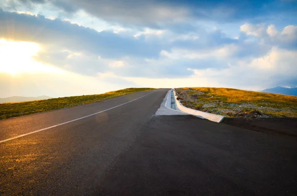 Road at sunset over the hill — Stock Photo, Image