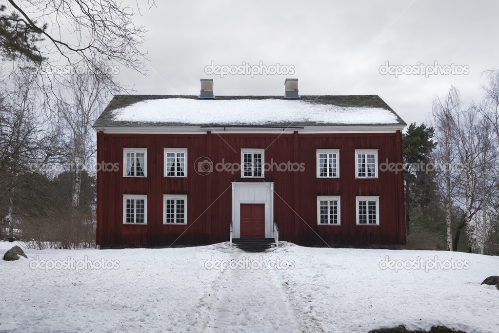 Big wooden red house and snow