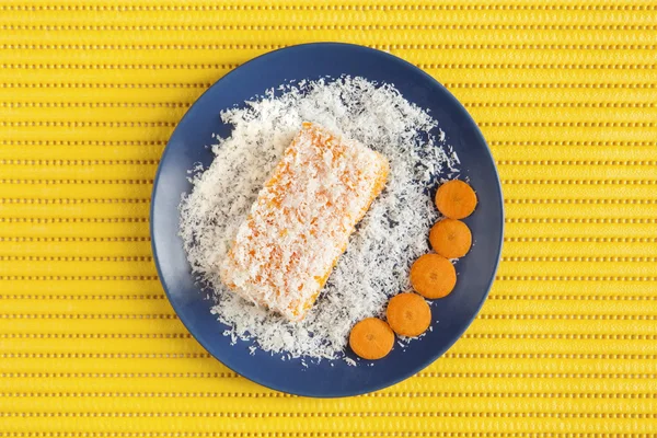 Carrot and coconut cake on yellow surface — Stock Photo, Image