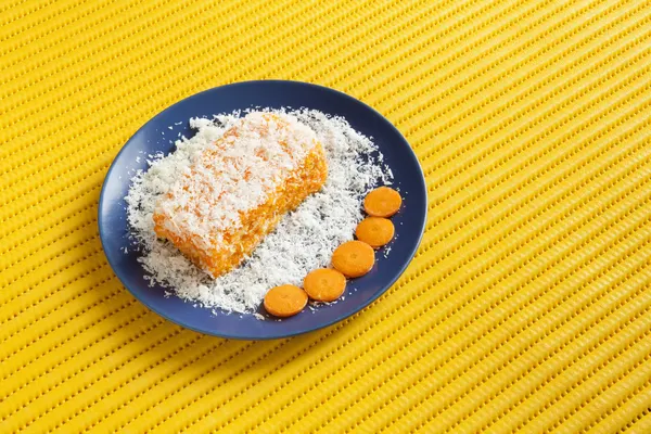 Carrot and coconut cake with yellow background — Stock Photo, Image