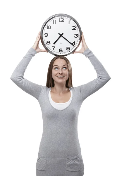 Looking at the clock above her head — Stock Photo, Image