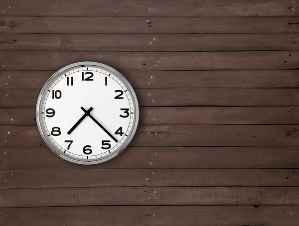 Clock on a brown wooden wall — Stock Photo, Image