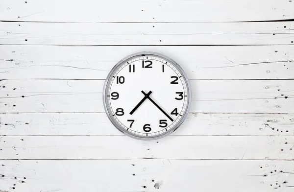 Clock on a white plank — Stock Photo, Image