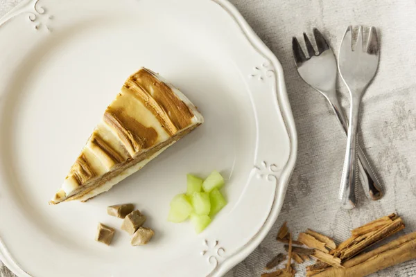 Melon and caramel cake slice with forks — Stock Photo, Image