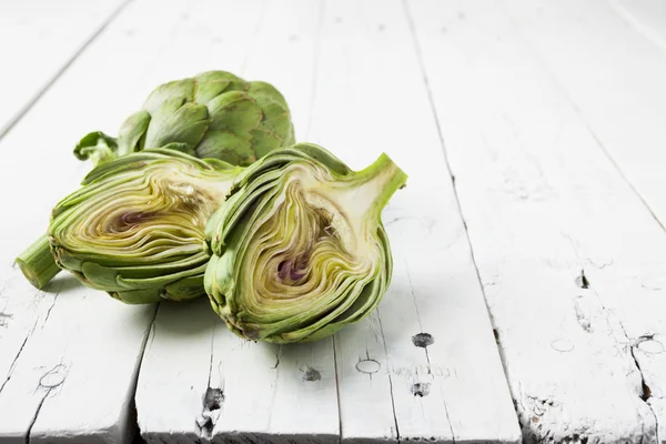 Artichoke cut in half on white with copy space — Stock Photo, Image