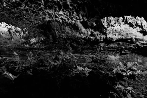 stock image Dark, colorful Textures of the walls in a lava tube of Canaria island.