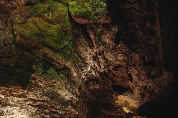 Dark, colorful Textures of the walls in a lava tube of Canaria island.