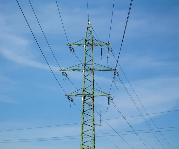 Panorama high voltage tower with power lines. Bottom view of high voltage pole power transmission tower. Green energy, environmental conservation concept.