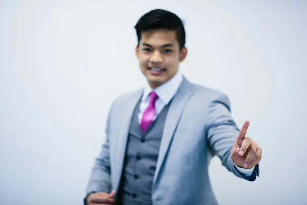Young businessman touching invisible screen interface — Stock Photo, Image