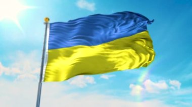 Güneşli bir günde bayrak direğinde dalgalanan Ukrayna bayrağı