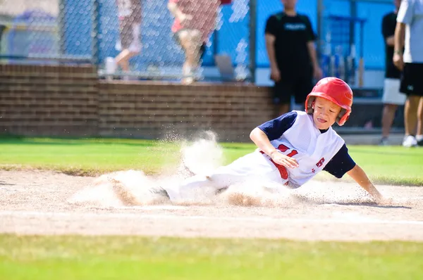 Jogador de beisebol deslizando para casa — Fotografia de Stock