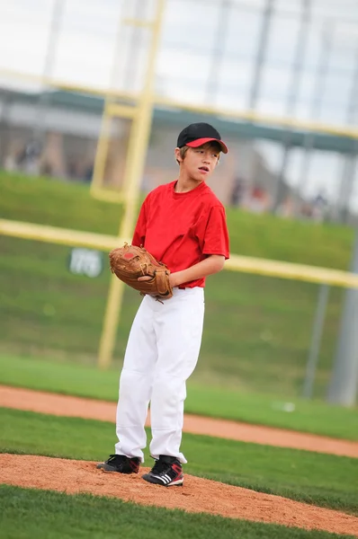 Little league pitcher in red looking. — Stock Photo, Image