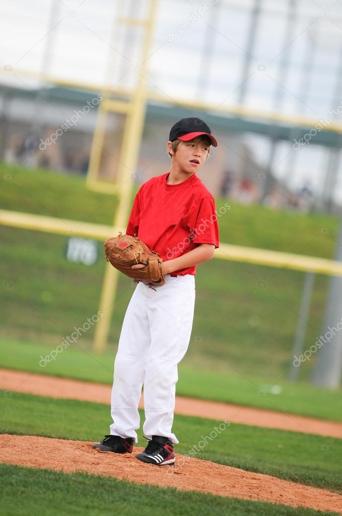 Little league pitcher in red looking.