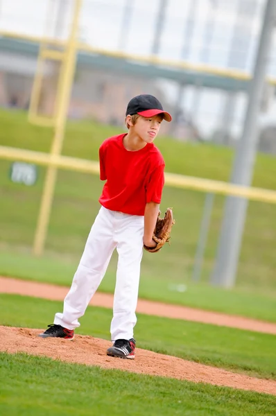 Youth baseball pitcher in red jersey — Stock Photo, Image