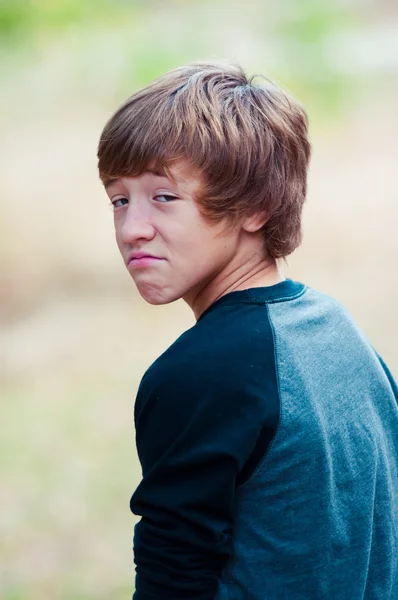 Young teen looking at camera with frown face — Stock Photo, Image